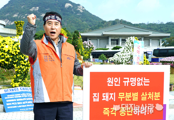 하태식 대한한돈협회장이 14일 청와대 분수광장앞에서 ASF 피해농가 보상촉구 1인시위를 진행하며 구호를 외치고 있다@한돈협회
